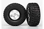 Two Traxxas 2.2/3.0 inch Kumho Road Venture MT tires pre-glued to satin chrome and black wheels against a white background.