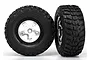Two Traxxas 2.2/3.0 inch Kumho Road Venture MT tires pre-glued onto satin chrome five-spoke wheels against a white background.