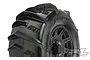 Close-up of a Pro-Line 3.8 inch Dumont paddle tyre mounted on a black Raid rim, showing the aggressive tread pattern and branding.