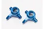 Two blue anodized aluminium steering blocks for Traxxas RC vehicles, shown from a top-down perspective on a white background.