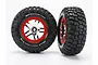 Two Traxxas 2.2/3.0 inch BFGoodrich Mud Terrain T/A KM2 tyres pre-glued onto chrome and red split-spoke wheels against a white background.