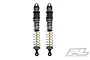Two Pro-Line PowerStroke threaded RC shock absorbers with gunmetal bodies, silver springs, and gold shafts against a white background.