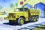 Box art illustration of an Academy 1/72 scale M35 2.5-ton cargo truck in a desert setting with a building and palm trees in the background.