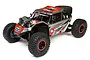 Losi Super Rock Rey V2 1/6 scale RC rock racer in grey and red livery, featuring off-road tires, roll cage, and LED light bars on a white background.