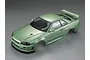 A high-angle studio shot of a 1/10 scale Nissan Skyline R34 RC car body shell painted in a metallic champagne green finish.