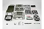 A 1/10 scale Toyota Land Cruiser 70 hard body kit by Killerbody in military green, featuring unassembled plastic parts, decals, and hardware on a white background.