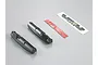 Killerbody 1/10 Toyota Land Cruiser 70 dashboard parts including two black plastic dashboard sections, a strip of double-sided tape, and a decal sheet.