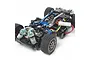A high-angle studio shot of a Tamiya M-05 Ver II Pro 1/10 scale RC car chassis, showing blue anodized aluminum parts, black plastic components, and rubber tires.