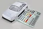 A white 1/10 scale RC car body shell with black trim and an accompanying sheet of decals on a plain grey background.