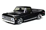 A studio shot of a black 1/10 scale Losi V-100 1972 Chevy C10 RC pickup truck on a white background.
