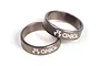 Two grey metal Axial drive shaft retainer rings with the Axial logo laser-etched on the side, isolated on a white background.