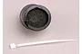 A black foam air filter element and a white plastic zip tie on a light grey background.