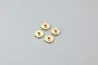 Four small, circular brass shock pistons for RC cars arranged in a square pattern on a plain light grey background.