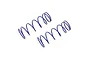 Two blue Kyosho RC shock springs lying diagonally on a white background.
