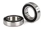 Two Traxxas 12x21x5mm ball bearings with black rubber seals, one lying flat and one standing upright on a white background.