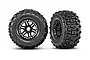 Two Traxxas Sledgehammer RC monster truck wheels with aggressive tread patterns and black dual-spoke rims, shown from front and side angles.