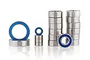 A collection of metal ball bearings with blue rubber seals, arranged in stacks and individually on a white background.
