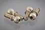 Four silver-coloured metal pivot balls with threaded shafts arranged on a reflective grey surface.