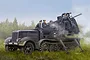 Box art illustration of a German Sd.Kfz.7/2 half-track with a 5cm FLAK 41 anti-aircraft gun and crew in a field.