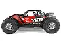 Side profile of the Axial Yeti XL 1/8 scale RC monster buggy in red and black with sponsor decals and a driver figure.