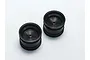Two black Kyosho RC car rear rims viewed from a high angle against a plain white background.
