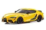A studio shot of a yellow Kyosho Mini-Z Toyota GR Supra RC car with black wheels and aero body kit details against a white background.