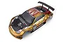 A bronze painted 1/10 scale RC car body shell with carbon fiber style hood and racing decals, viewed from a high angle against a white background.