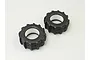 Two black rubber paddle tyres for RC monster trucks, shown from an angled top-down perspective against a plain light background.