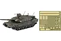 A 1/72 scale model of a JGSDF Type 10 tank in camouflage paint next to a sheet of photo-etched metal detail parts.