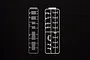 Two plastic model kit sprues for a 1/32 scale truck accessory set, featuring various small parts on a black background.