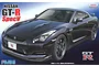 Box art for a Fujimi 1/24 scale Nissan GT-R Spec-V plastic model kit featuring a dark purple sports car against a blue gradient background.