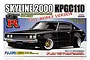 Fujimi 1/24 scale model kit box art for a black Nissan Skyline 2000 GT-R KPGC110 Full-Works Version with wide fender flares.