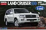 Box art for a Fujimi 1/24 scale Toyota Landcruiser 100 model kit featuring a white SUV parked on rocky terrain.