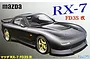 Box art for a Fujimi 1/24 scale Mazda RX-7 FD3S Kai plastic model kit featuring a dark grey sports car with gold wheels.
