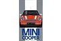 Front view of an orange Mini Cooper model kit box art featuring a white roof and racing stripes.