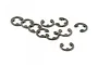 A collection of ten small metal E-clips scattered on a plain white background.