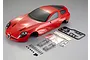A red 1/10 scale Alfa Romeo TZ3 Corsa RC body shell with included plastic accessories, screws, and mounting hardware on a grey background.