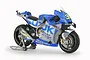 A 1/12 scale Tamiya plastic model kit of the Team Suzuki ECSTAR GSX-RR 2020 motorcycle, featuring blue and silver livery on a display stand.
