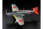 A high-angle studio shot of a finished 1/48 scale Tamiya Kawasaki Ki-61 Hien model aircraft with a silver-plated finish and camouflage markings.