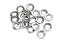 A pile of small silver-coloured metal spring washers on a white background.