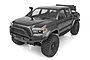 Element RC Enduro Knightrunner 1/10 scale RC rock crawler truck in black, featuring a detailed pickup body, off-road tires, and a front bumper.