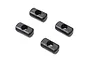 Four small black rectangular plastic axle bushings with a central hexagonal hole, arranged on a white background.