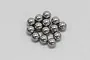 A cluster of fourteen small, polished steel ball bearings arranged on a plain white background.