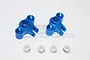 Two blue anodized aluminium RC axle carriers with four small white plastic bushings on a white background.