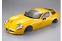 A yellow Killerbody 1/10 scale Alfa Romeo TZ3 Corsa RC car body shell viewed from a high angle against a grey background.