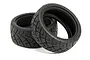 Two black HPI Racing rubber RC car tyres with an X-pattern tread design, shown against a white background.