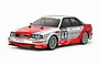 A 1/10 scale Tamiya TT-02 RC model of the 1992 Audi V8 touring car, featuring a silver and red racing livery with sponsor decals on a white background.