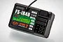 FlySky FS-IR4B 4-channel RC receiver unit with black plastic casing and connection ports.