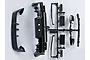 Black plastic injection molded RC car accessory parts for a Mitsubishi Lancer Evolution X, including a spoiler, bumper, and side mirrors on a sprue.