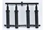 A set of four black plastic RC body posts still attached to their original injection molding sprue tree.